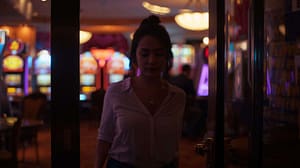 Woman quietly leaving a gaming venue while reflecting on gambling addiction recovery and emotional wellbeing.